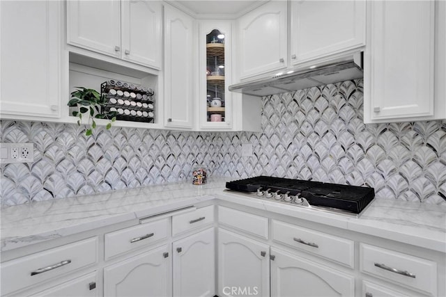 1048 Gladstone St, La Verne, CA 91750 - kitchen featuring stainless steel gas stovetop, white cabinetry, under cabinet range hood, and glass insert cabinets