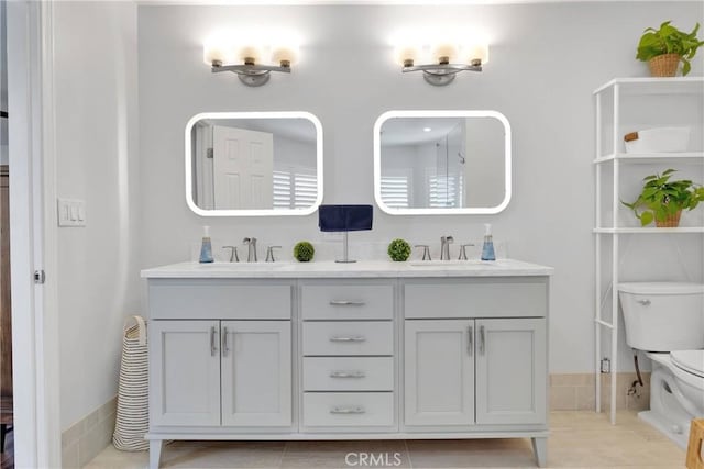 1048 Gladstone St, La Verne, CA 91750 - bathroom with double vanity, toilet, and tile patterned flooring