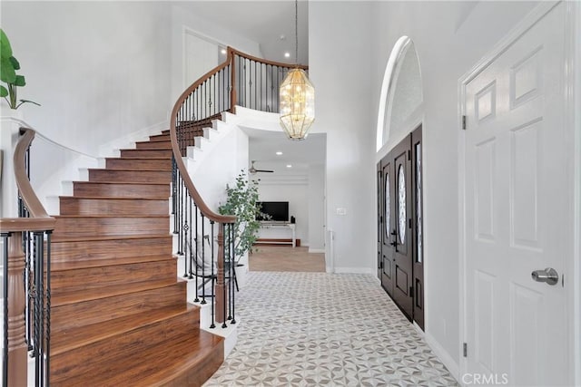 1048 Gladstone St, La Verne, CA 91750 - entrance foyer with a towering ceiling, stairs, carpet floors, a chandelier, and baseboards