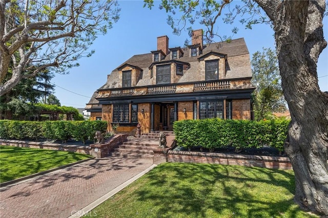 11 La Linda Dr, Long Beach, CA 90807 - view of front facade featuring brick siding, a chimney, a balcony, and a front yard