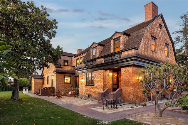 11 La Linda Dr, Long Beach, CA 90807 - back of property with a balcony, a lawn, a chimney, and a gambrel roof