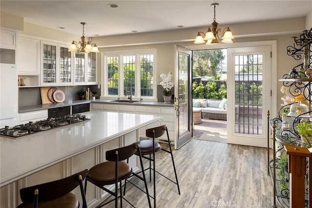 11 La Linda Dr, Long Beach, CA 90807 - kitchen featuring a chandelier, a sink, stainless steel gas cooktop, and plenty of natural light