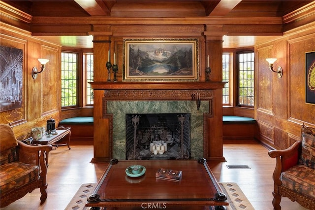 11 La Linda Dr, Long Beach, CA 90807 - living room featuring light wood finished floors, healthy amount of natural light, wooden walls, a fireplace, and crown molding