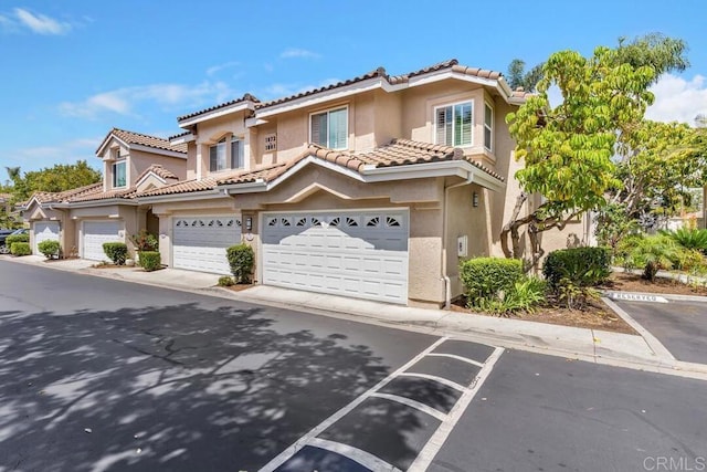 1873 Key Largo Rd, Vista, CA 92081 - view of property with stucco siding, a tile roof, and an attached garage
