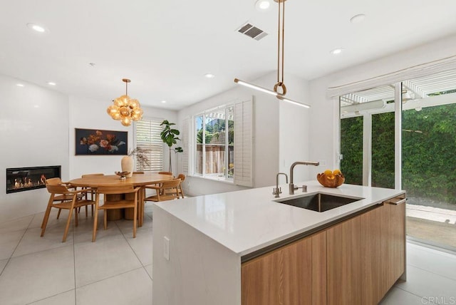 16863 Abundante St, San Diego, CA 92127 - kitchen with a sink, modern cabinets, light tile patterned floors, a kitchen island with sink, and recessed lighting