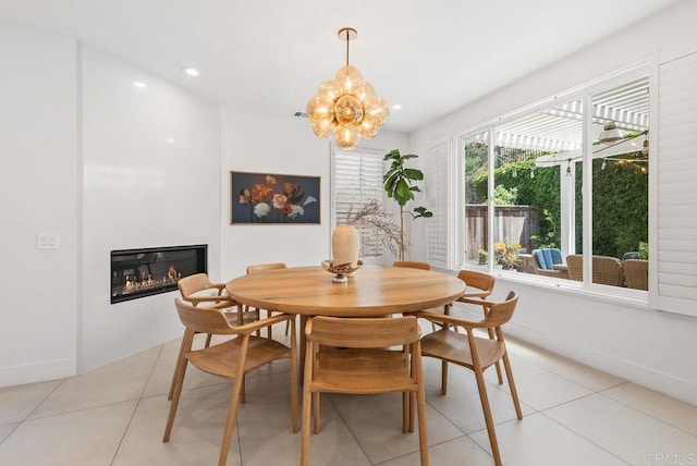 16863 Abundante St, San Diego, CA 92127 - dining space featuring light tile patterned flooring, a glass covered fireplace, a chandelier, baseboards, and recessed lighting