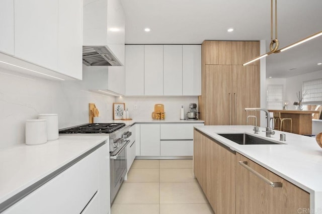 16863 Abundante St, San Diego, CA 92127 - kitchen with custom exhaust hood, a sink, high end stove, modern cabinets, and light countertops