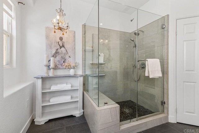16863 Abundante St, San Diego, CA 92127 - bathroom with tile patterned flooring, a shower stall, a chandelier, and baseboards