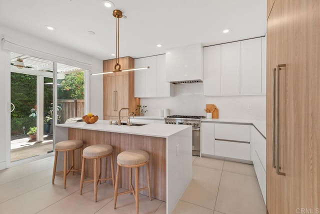 16863 Abundante St, San Diego, CA 92127 - kitchen featuring a sink, stainless steel range, modern cabinets, white cabinetry, and light countertops