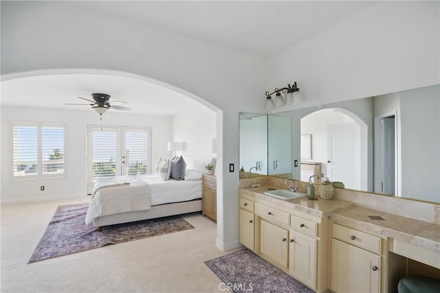 2585 Barcelona, Pismo Beach, CA 93449 - bedroom with arched walkways, a sink, and light colored carpet