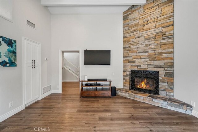 26882 Ayamonte, Mission Viejo, CA 92692 - living room featuring a fireplace, wood finished floors, stairs, baseboards, and beamed ceiling