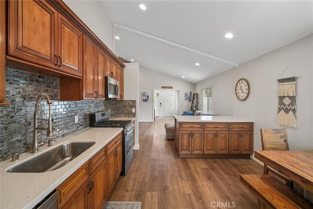 26882 Ayamonte, Mission Viejo, CA 92692 - kitchen with stainless steel appliances, a sink, vaulted ceiling, light countertops, and tasteful backsplash