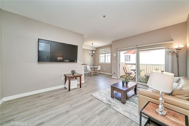 300 E Providencia Ave Unit 211, Burbank, CA 91502 - living room with baseboards, light wood finished floors, and a chandelier
