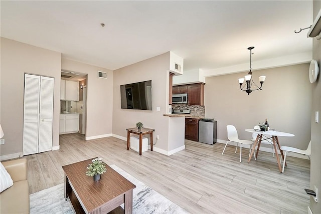 300 E Providencia Ave Unit 211, Burbank, CA 91502 - living area featuring light wood-type flooring, a chandelier, and baseboards