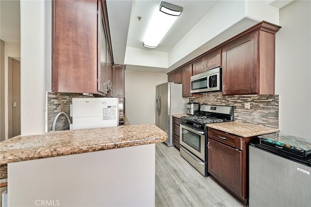 300 E Providencia Ave Unit 211, Burbank, CA 91502 - kitchen featuring stainless steel appliances, backsplash, light wood-style flooring, and dark brown cabinets