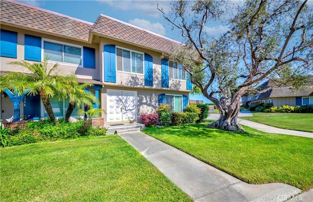 4394 Dina Ct, Cypress, CA 90630 - townhome / multi-family property with a shingled roof, stucco siding, a front yard, and mansard roof