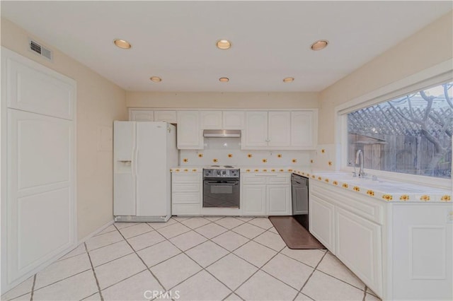 4394 Dina Ct, Cypress, CA 90630 - kitchen with white refrigerator with ice dispenser, electric range, under cabinet range hood, dishwashing machine, and light countertops
