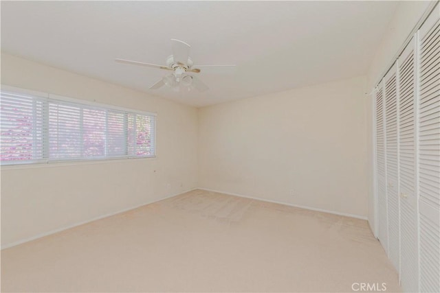 4394 Dina Ct, Cypress, CA 90630 - unfurnished bedroom featuring a closet, light carpet, baseboards, and ceiling fan