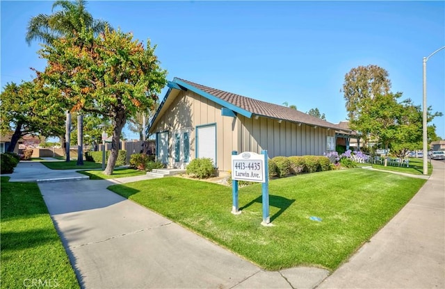 4394 Dina Ct, Cypress, CA 90630 - surrounding community featuring a yard and a garage