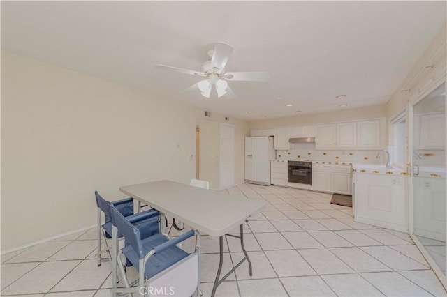 4394 Dina Ct, Cypress, CA 90630 - unfurnished dining area featuring light tile patterned floors, a sink, ceiling fan, and baseboards