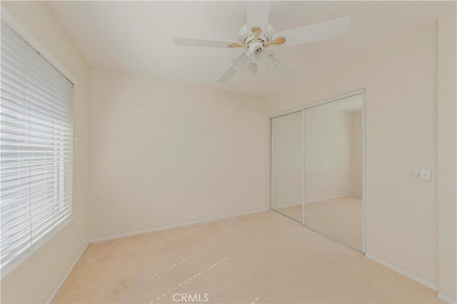 4394 Dina Ct, Cypress, CA 90630 - unfurnished bedroom with carpet flooring, a closet, baseboards, and ceiling fan