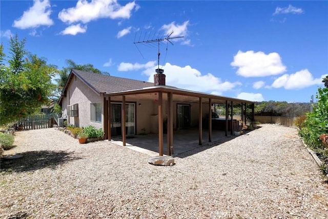 30124 Casa Chata Pl, Temecula, CA 92592 - back of house with a chimney, a patio area, and stucco siding