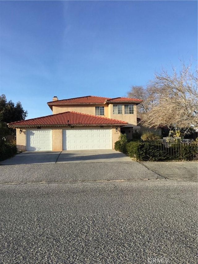 17590 El Cajon Dr, Hesperia, CA 92345 - mediterranean / spanish house with a tiled roof, a garage, stucco siding, concrete driveway, and a chimney