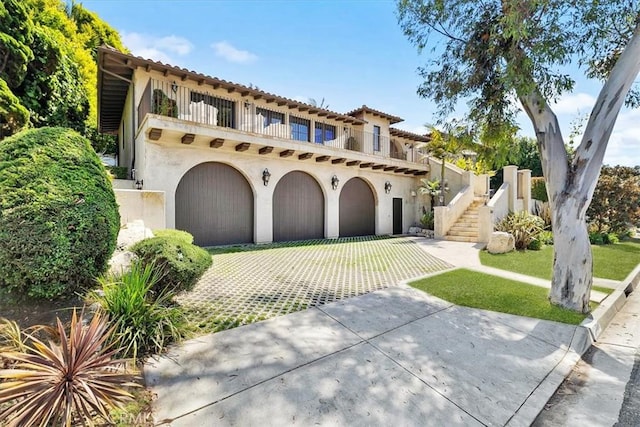364 Via Almar, Palos Verdes Estates, CA 90274 - mediterranean / spanish-style home featuring a balcony, stucco siding, a garage, a tile roof, and stairs