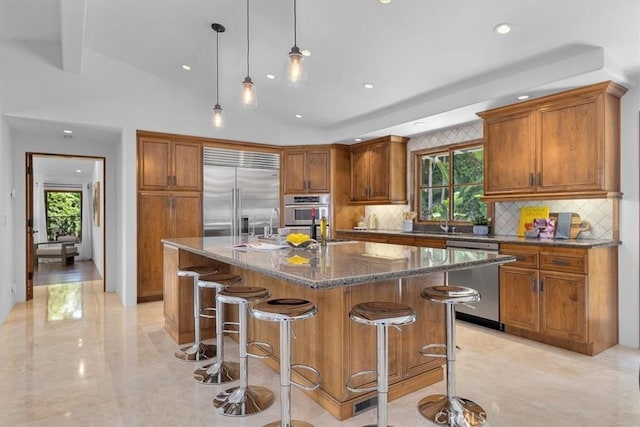 364 Via Almar, Palos Verdes Estates, CA 90274 - kitchen with stainless steel appliances, backsplash, brown cabinets, a kitchen bar, and recessed lighting