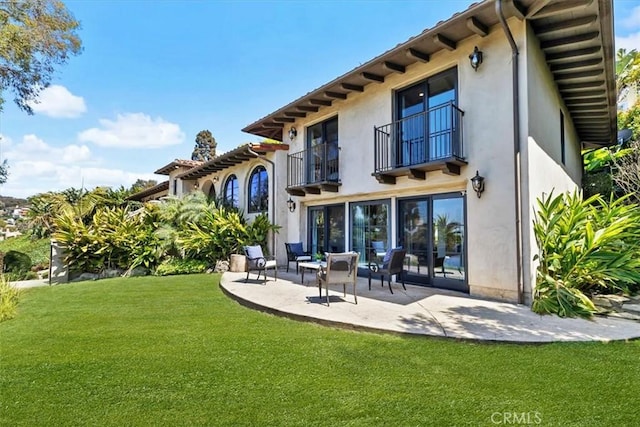 364 Via Almar, Palos Verdes Estates, CA 90274 - back of house featuring a balcony, a patio, stucco siding, and a yard