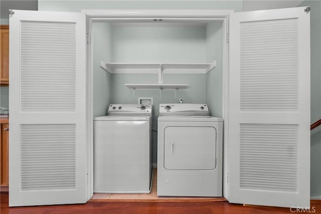 15721 Cobalt St Unit 118, Sylmar, CA 91342 - laundry room with washing machine and clothes dryer and wood finished floors
