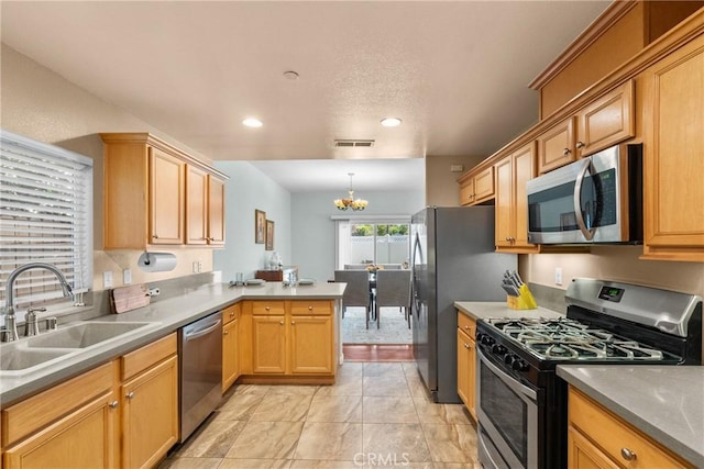 15721 Cobalt St Unit 118, Sylmar, CA 91342 - kitchen with stainless steel appliances, a chandelier, a peninsula, recessed lighting, and pendant lighting