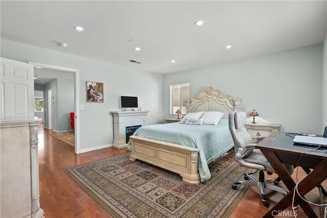 15721 Cobalt St Unit 118, Sylmar, CA 91342 - bedroom with wood finished floors, a desk, recessed lighting, and a glass covered fireplace