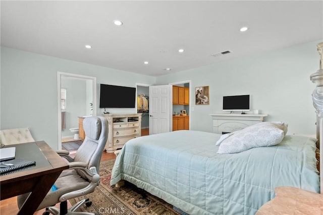 15721 Cobalt St Unit 118, Sylmar, CA 91342 - bedroom with an office area, recessed lighting, a walk in closet, wood finished floors, and ensuite bathroom