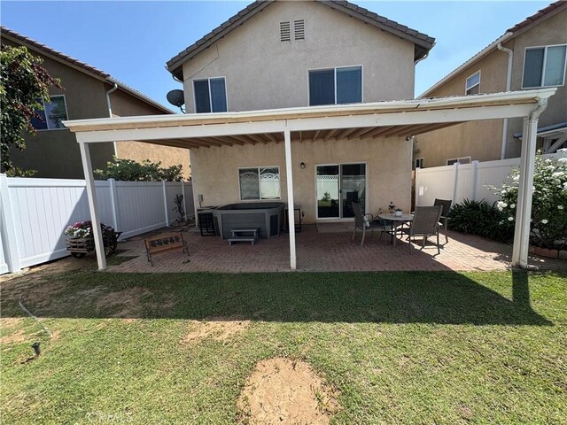 15721 Cobalt St Unit 118, Sylmar, CA 91342 - rear view of house with a hot tub, stucco siding, a patio, and a tiled roof