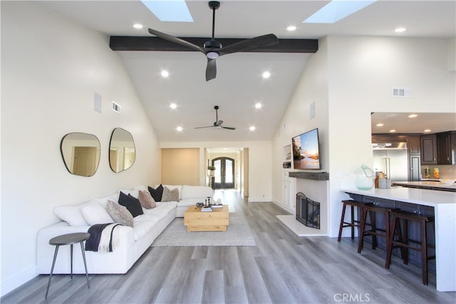 4374 Mahogany Cir, Yorba Linda, CA 92886 - living room featuring a skylight, high vaulted ceiling, ceiling fan, wood finished floors, and beamed ceiling