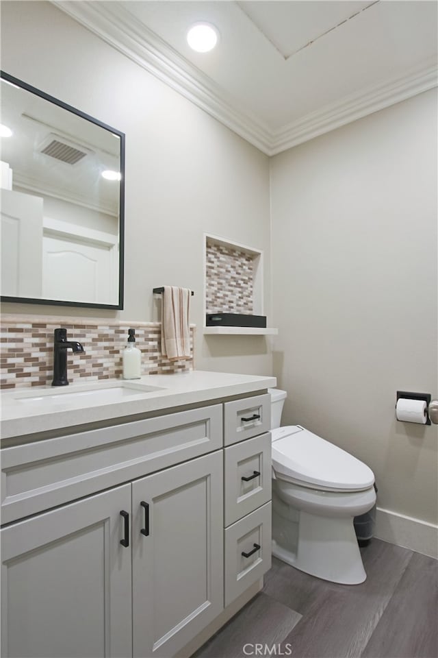 4374 Mahogany Cir, Yorba Linda, CA 92886 - bathroom with toilet, wood finished floors, vanity, ornamental molding, and tasteful backsplash
