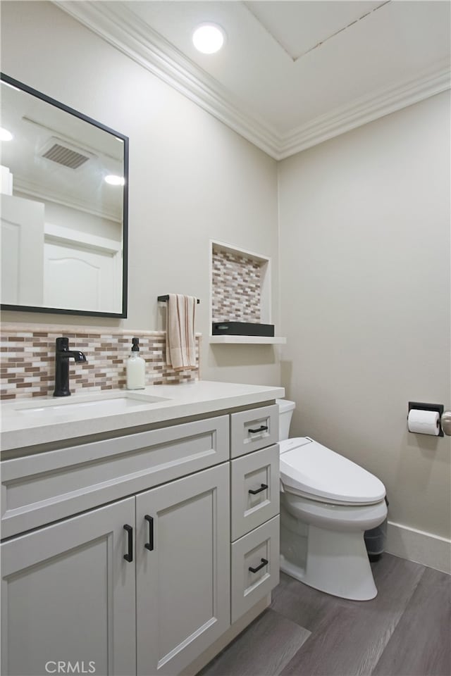 4374 Mahogany Cir, Yorba Linda, CA 92886 - half bathroom with wood finished floors, vanity, decorative backsplash, crown molding, and recessed lighting