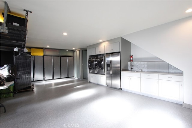 4374 Mahogany Cir, Yorba Linda, CA 92886 - garage featuring stainless steel fridge with ice dispenser, washer and dryer, and recessed lighting