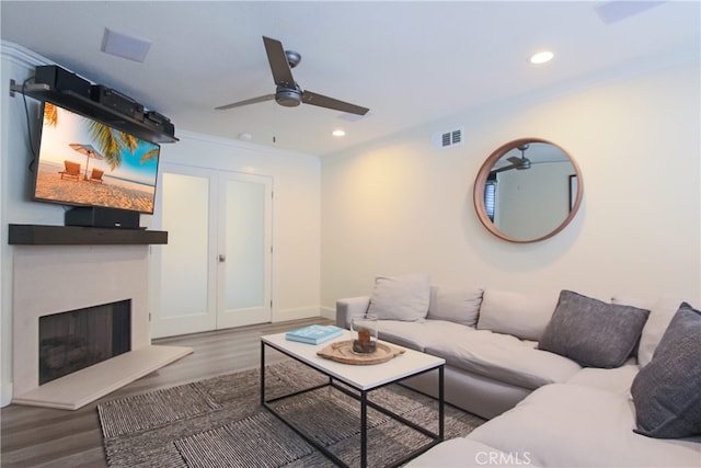 4374 Mahogany Cir, Yorba Linda, CA 92886 - living room with ceiling fan, a fireplace with raised hearth, wood finished floors, ornamental molding, and recessed lighting