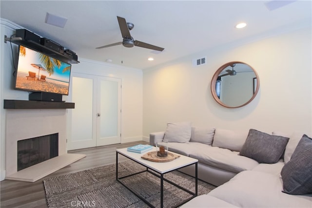 4374 Mahogany Cir, Yorba Linda, CA 92886 - living area with a ceiling fan, a fireplace with raised hearth, wood finished floors, recessed lighting, and ornamental molding