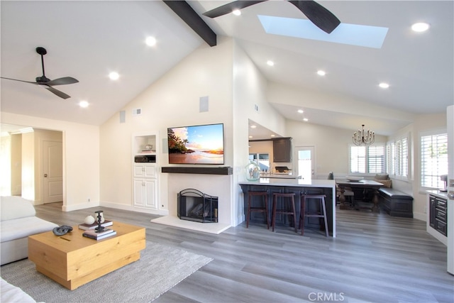 4374 Mahogany Cir, Yorba Linda, CA 92886 - living room with a fireplace with raised hearth, light wood finished floors, high vaulted ceiling, a chandelier, and beam ceiling