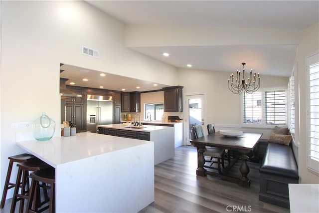 4374 Mahogany Cir, Yorba Linda, CA 92886 - kitchen featuring built in refrigerator, vaulted ceiling, a chandelier, a sink, and light countertops