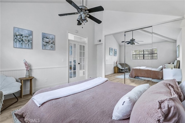 2633 Monte Carlo Unit 41, Santa Ana, CA 92706 - bedroom with french doors, wood finished floors, a closet, high vaulted ceiling, and wainscoting
