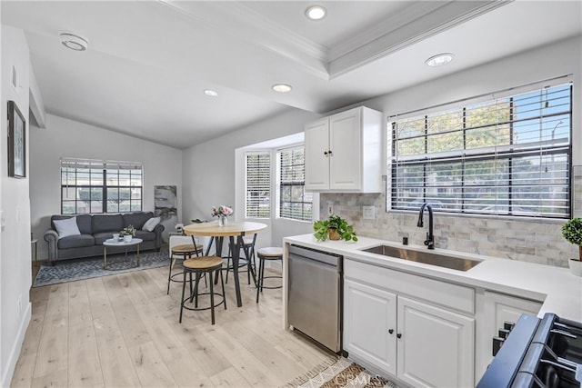 2633 Monte Carlo Unit 41, Santa Ana, CA 92706 - kitchen with stainless steel dishwasher, a sink, crown molding, tasteful backsplash, and light countertops