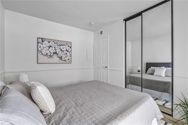 2633 Monte Carlo Unit 41, Santa Ana, CA 92706 - bedroom featuring a closet and wainscoting