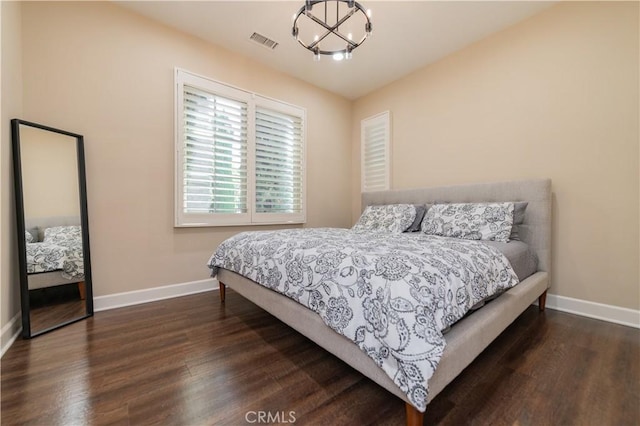 43 Lupari, Irvine, CA 92618 - bedroom with baseboards, dark wood-type flooring, and a chandelier