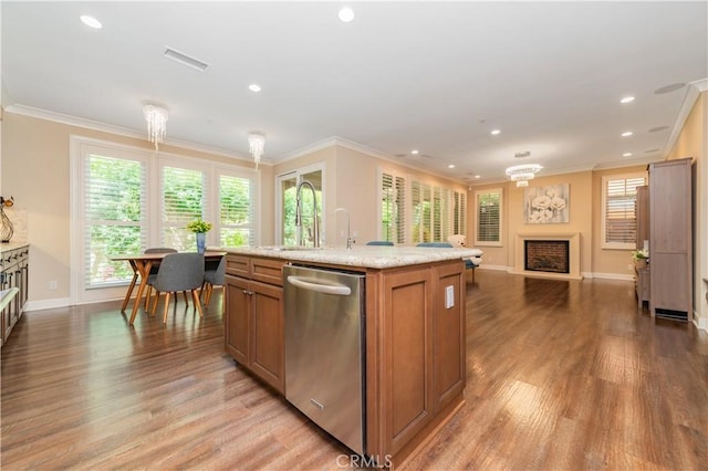 43 Lupari, Irvine, CA 92618 - kitchen featuring stainless steel dishwasher, light wood-style floors, open floor plan, a fireplace, and ornamental molding