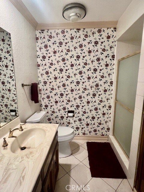 30417 Golden Gate Dr, Canyon Lake, CA 92587 - bathroom with vanity, a shower stall, tile patterned flooring, ornamental molding, and a textured wall