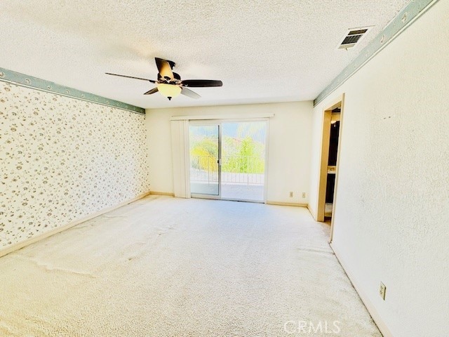 30417 Golden Gate Dr, Canyon Lake, CA 92587 - carpeted empty room with ceiling fan, a textured ceiling, and wallpapered walls